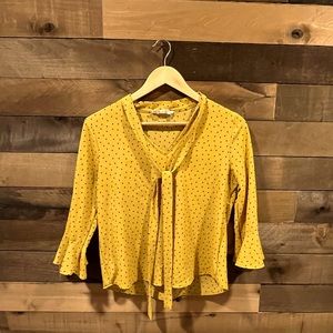 Mustard-colored, polka dot, bell sleeve top